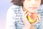 Child holding an apple, early detection and correction